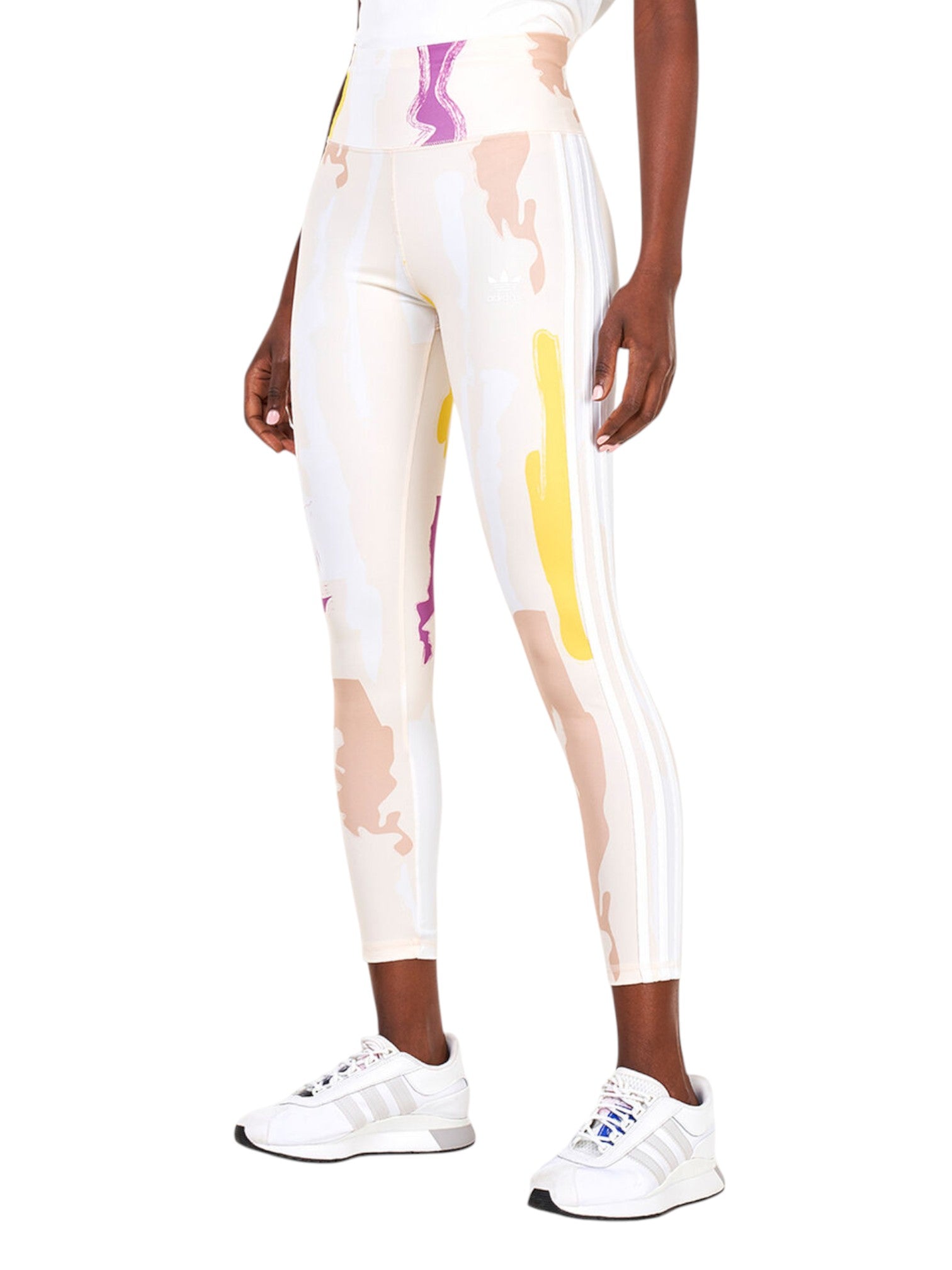 Person wearing a white leggings with colorful abstract design and Adidas shoes on a white background. Adidas, Monza Outlet, Monza Fashion, Shein Outlet