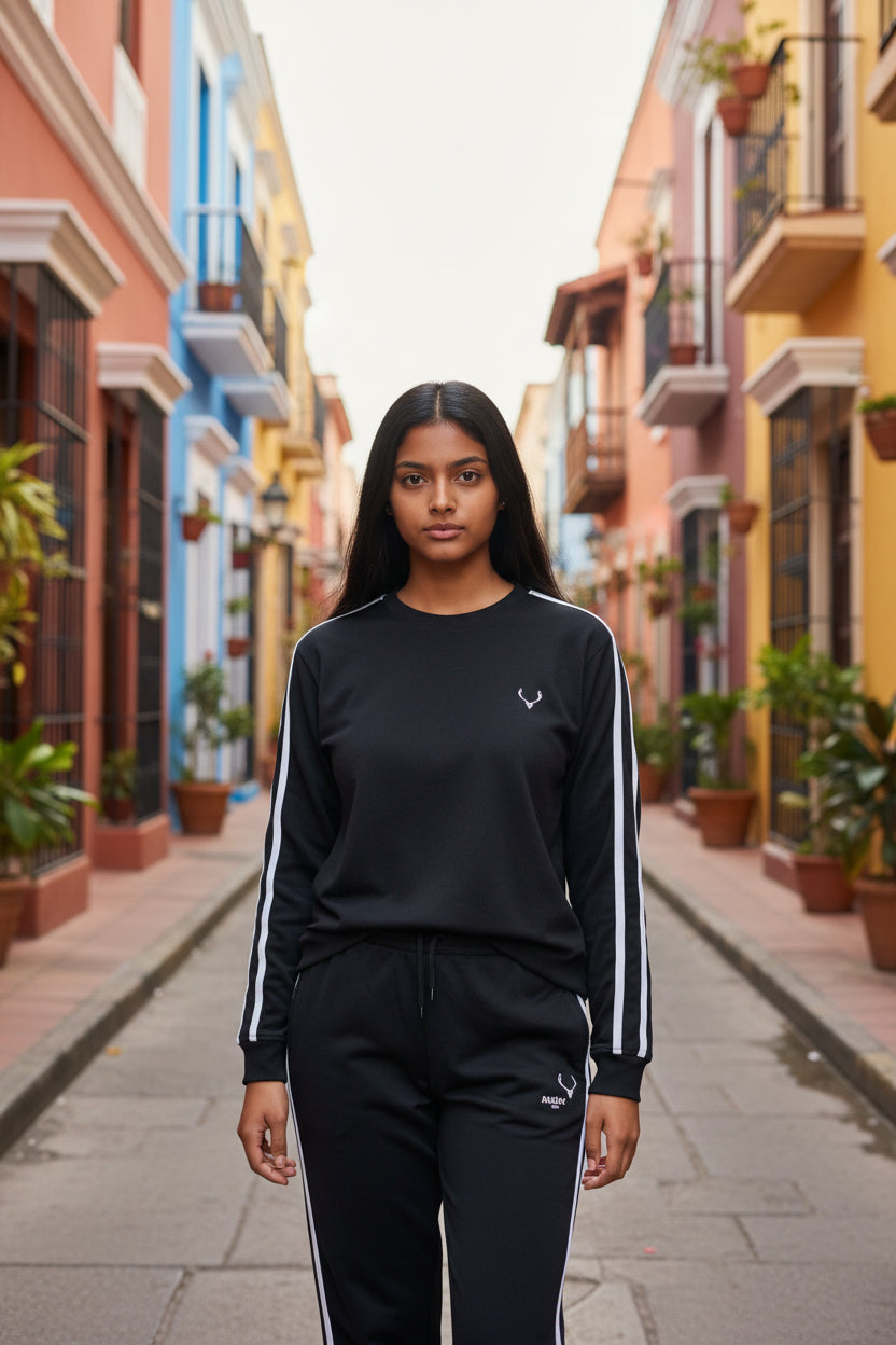 Person wearing a black outfit with white stripes in a colorful street setting. Antler, Monza Outlet, Monza Fashion, Shein Outlet