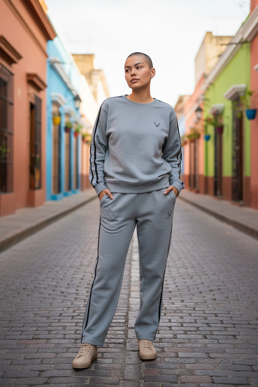 Person wearing a gray tracksuit standing on a colorful street. Antler, Monza Outlet, Monza Fashion, Shein Outlet