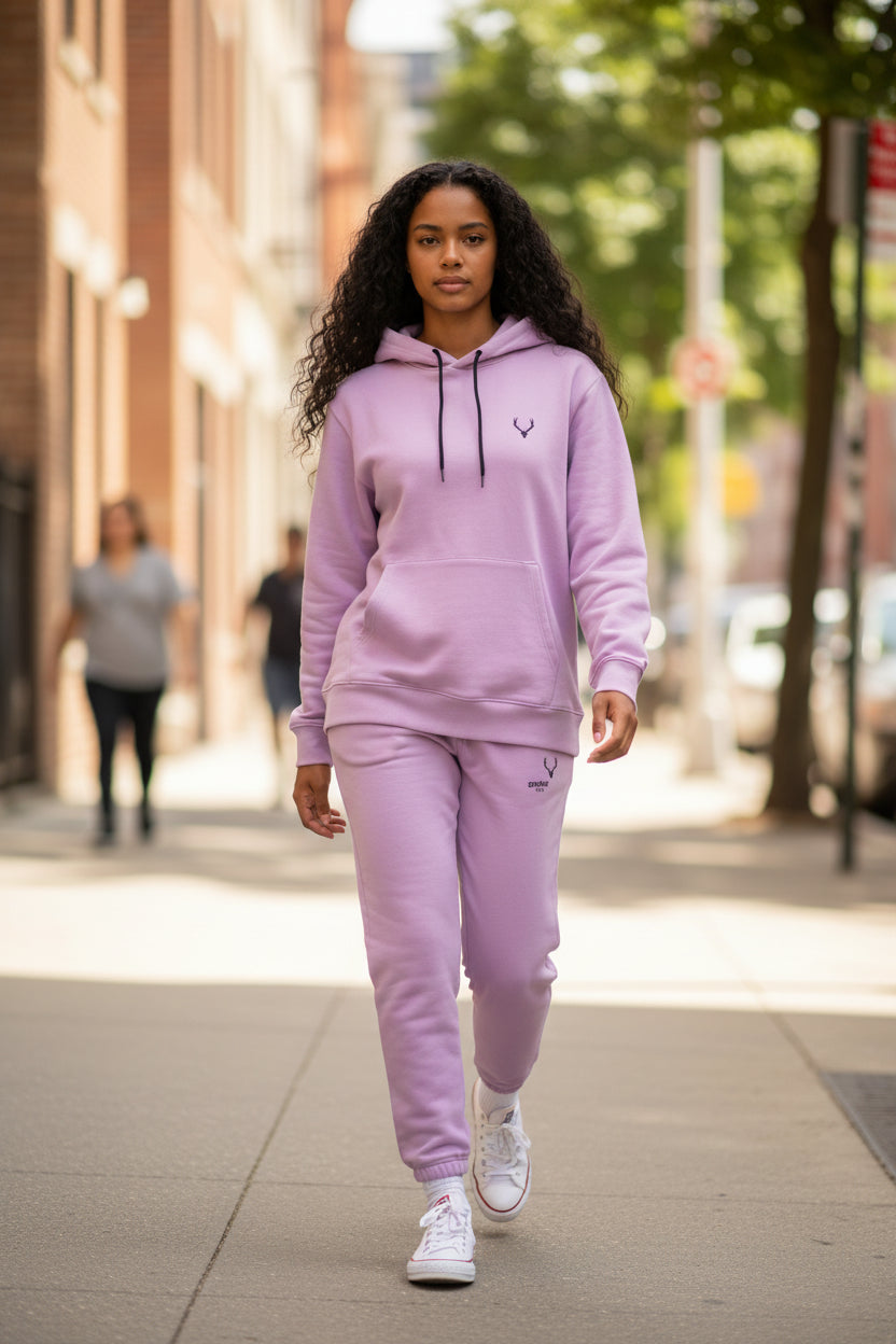 Person wearing a pink tracksuit walking on a city street. Antler, Monza Outlet, Monza Fashion, Shein Outlet