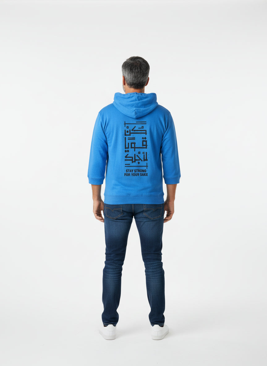 Person wearing a blue hoodie with text on the back, standing against a white background. Antler, Monza Outlet, Monza Fashion, Shein Outlet