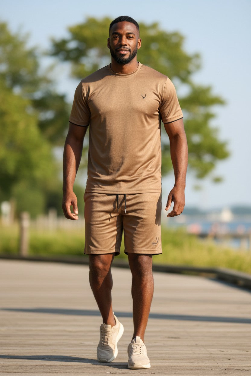 Man walking on a wooden path in a park wearing a brown t-shirt and shorts set. Antler, Monza Outlet, Monza Fashion, Shein Outlet