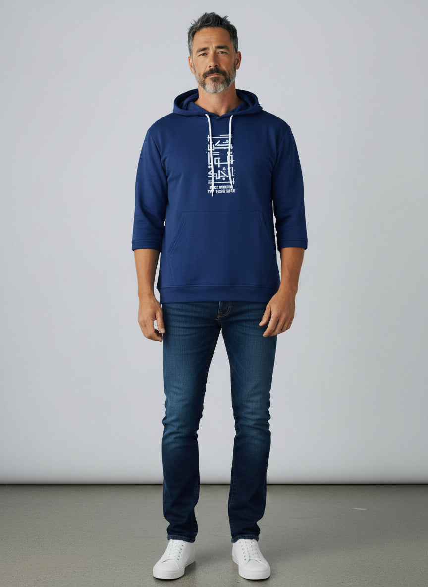 Man wearing a navy blue hoodie with white text and dark jeans on a plain background. Antler, Monza Outlet, Monza Fashion, Shein Outlet