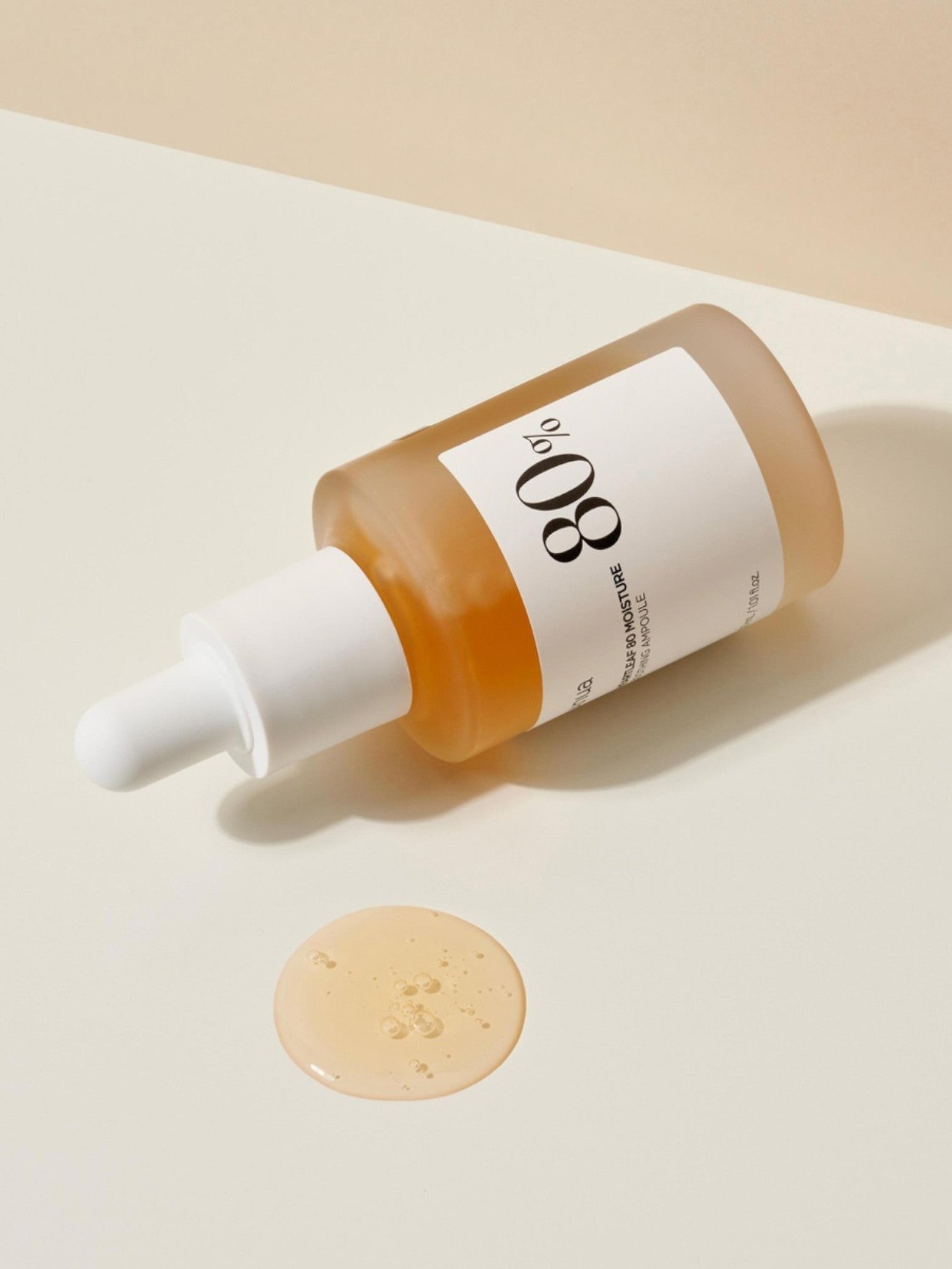 Skincare serum bottle with dropper on a beige background. Anua, Monza Outlet, Monza Fashion, Shein Outlet