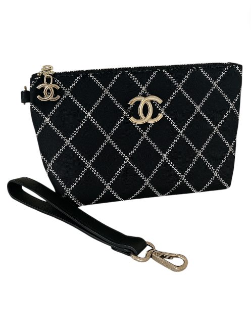 Black quilted handbag with gold logo on a white background. Chanel Monza Outlet