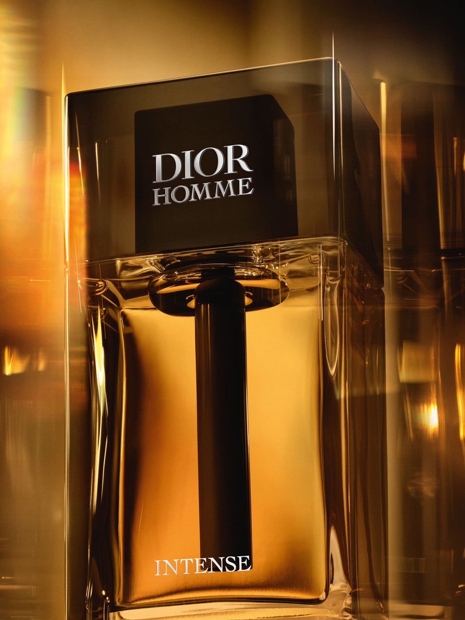 Dior Homme Intense perfume bottle with a reflective gold background. Dior, Monza Outlet, Monza Fashion, Shein Outlet
