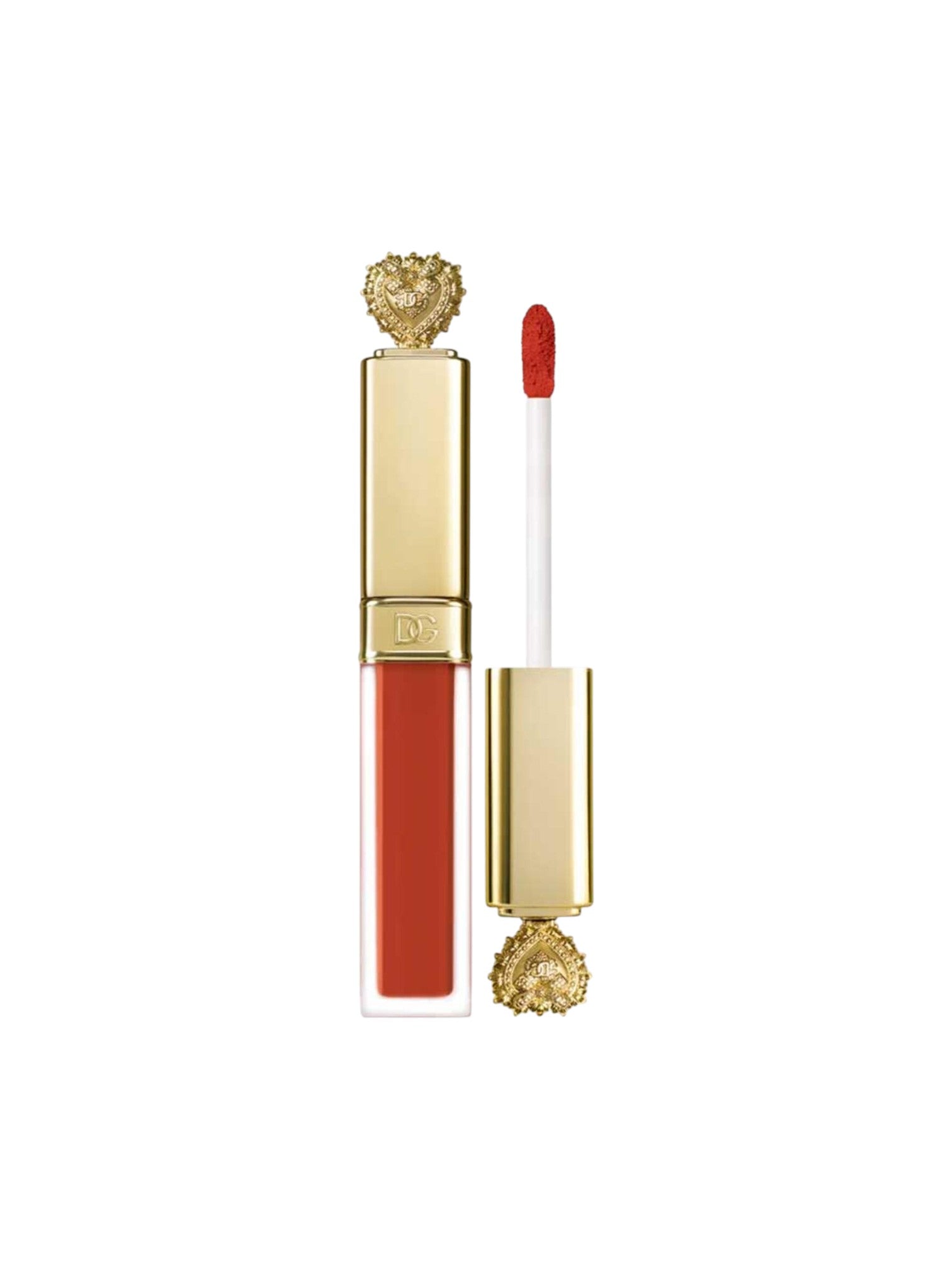 A liquid lipstick in a clear rectangular tube with a gold cap and a decorative gold heart shaped embellishment, shown closed next to the applicator wand with coral-red lipstick on a white background. Dolce & Gabbana, Monza Outlet, Monza Fashion, Shein Outlet