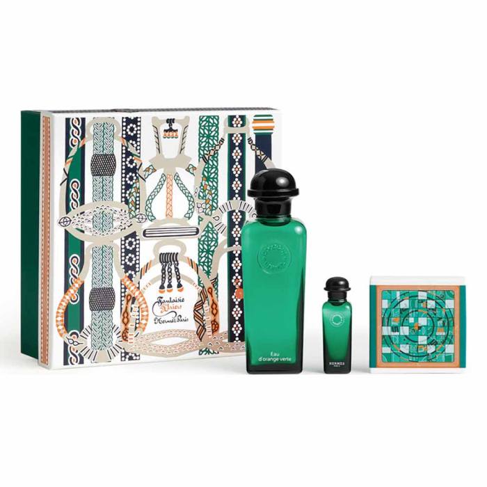 Green perfume bottles and packaging on a white background. Hermès Monza Outlet
