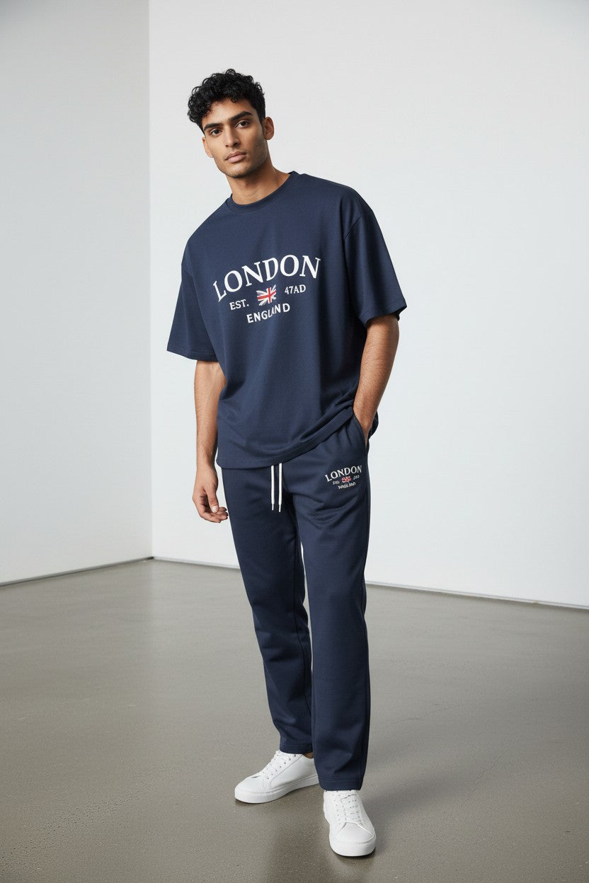 Man wearing a navy London t-shirt and tracksuit with white shoes on a plain background Antler, Monza Outlet, Monza Fashion, Shein Outlet