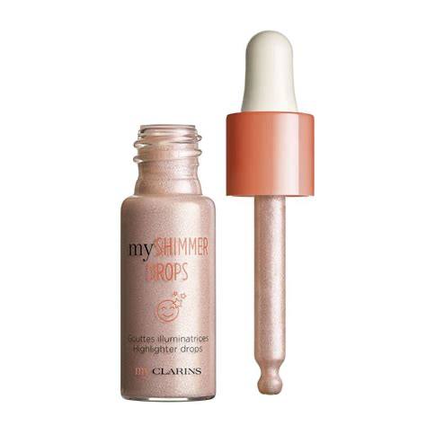Clarins myShimmer Drops highlighter bottle with applicator on a white background