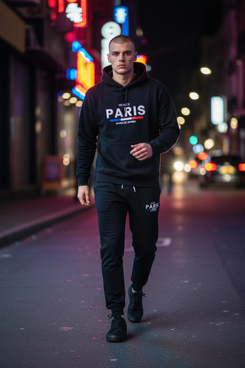 Man wearing a Paris hoodie walking on a city street at night. Antler, Monza Outlet, Monza Fashion, Shein Outlet