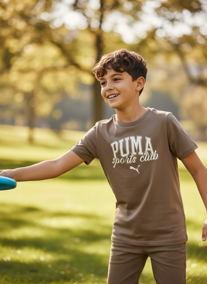 Child wearing a Puma sports club t-shirt in a park. Puma, Monza Outlet, Monza Fashion, Shein Outlet