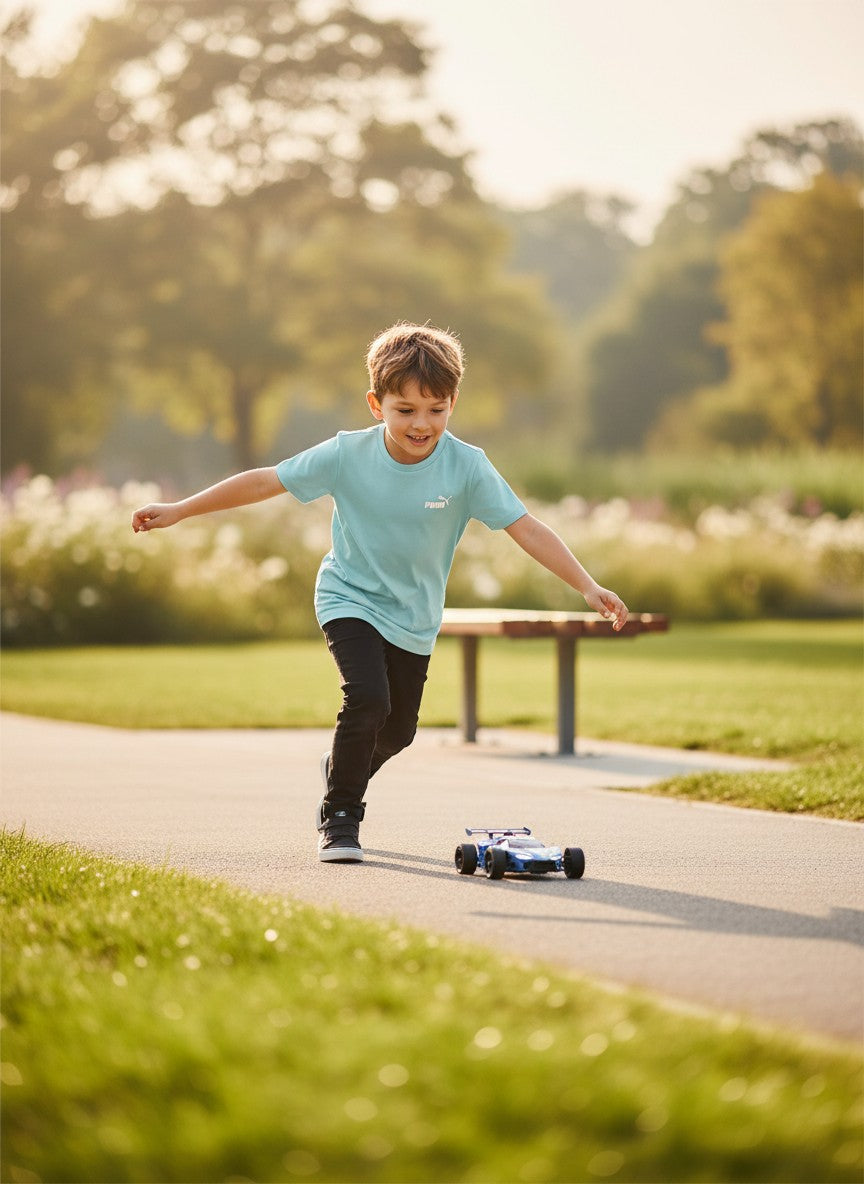 Child playing with a toy car on a path in a park. Puma, Monza Outlet, Monza Fashion, Shein Outlet