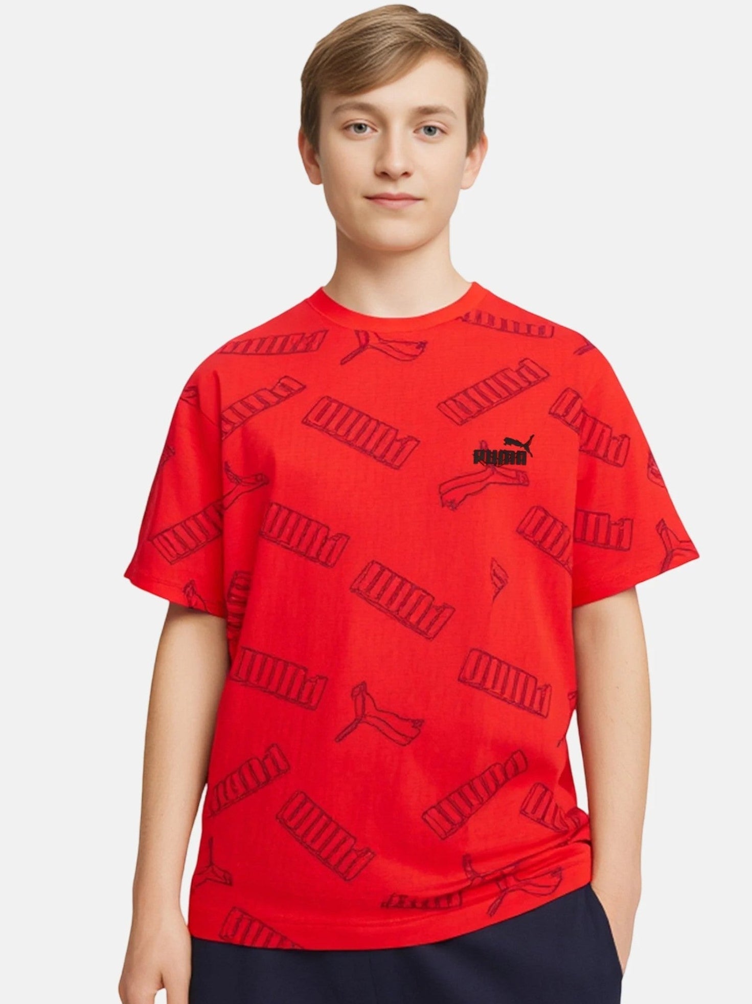 Person wearing a red t-shirt with black patterns and a logo on a white background. Puma, Monza Outlet, Monza Fashion, Shein Outlet
