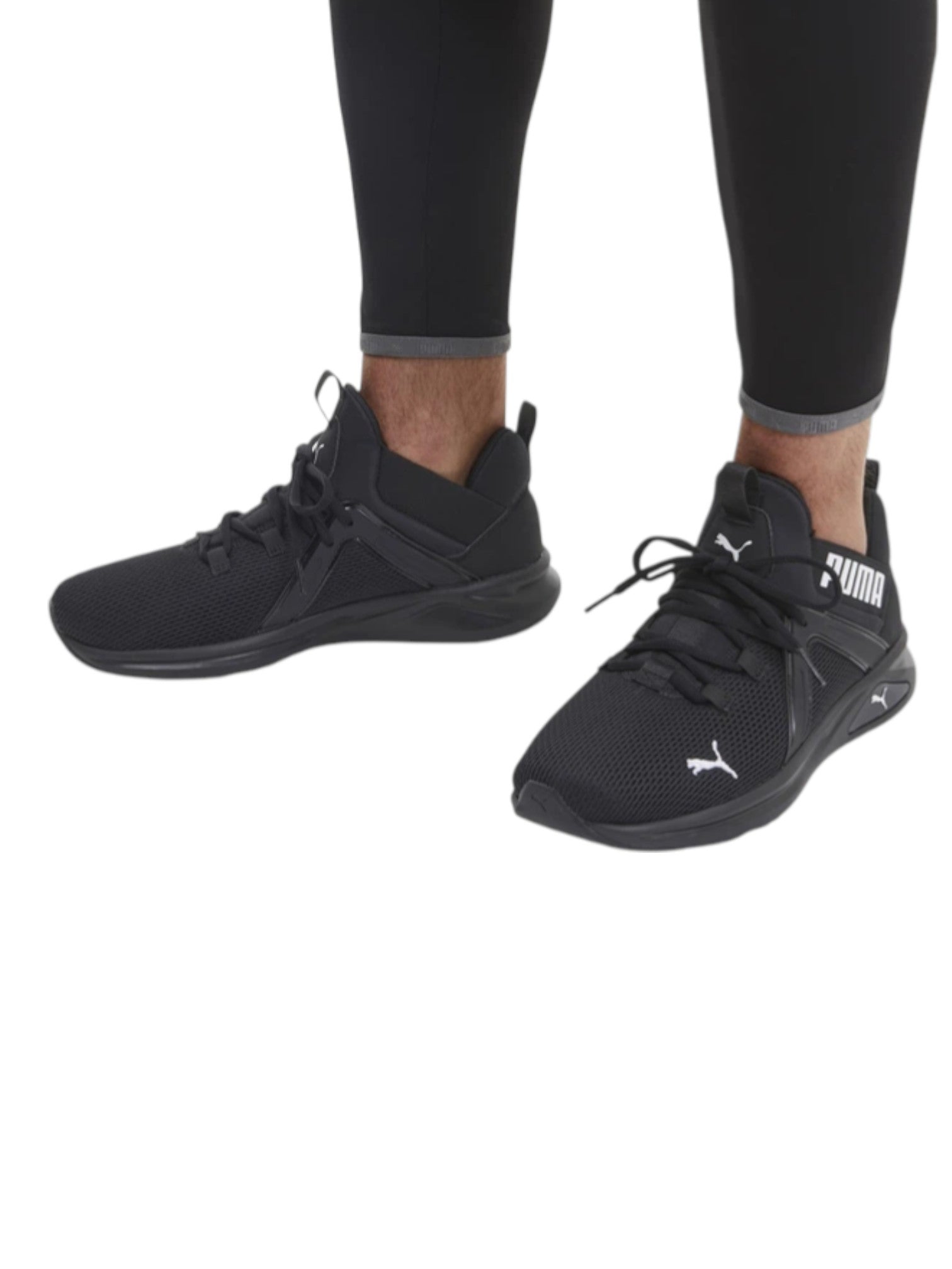 Black athletic shoes with Puma logo worn with black leggings on a white background. Puma, Monza Outlet, Monza Fashion, Shein Outlet