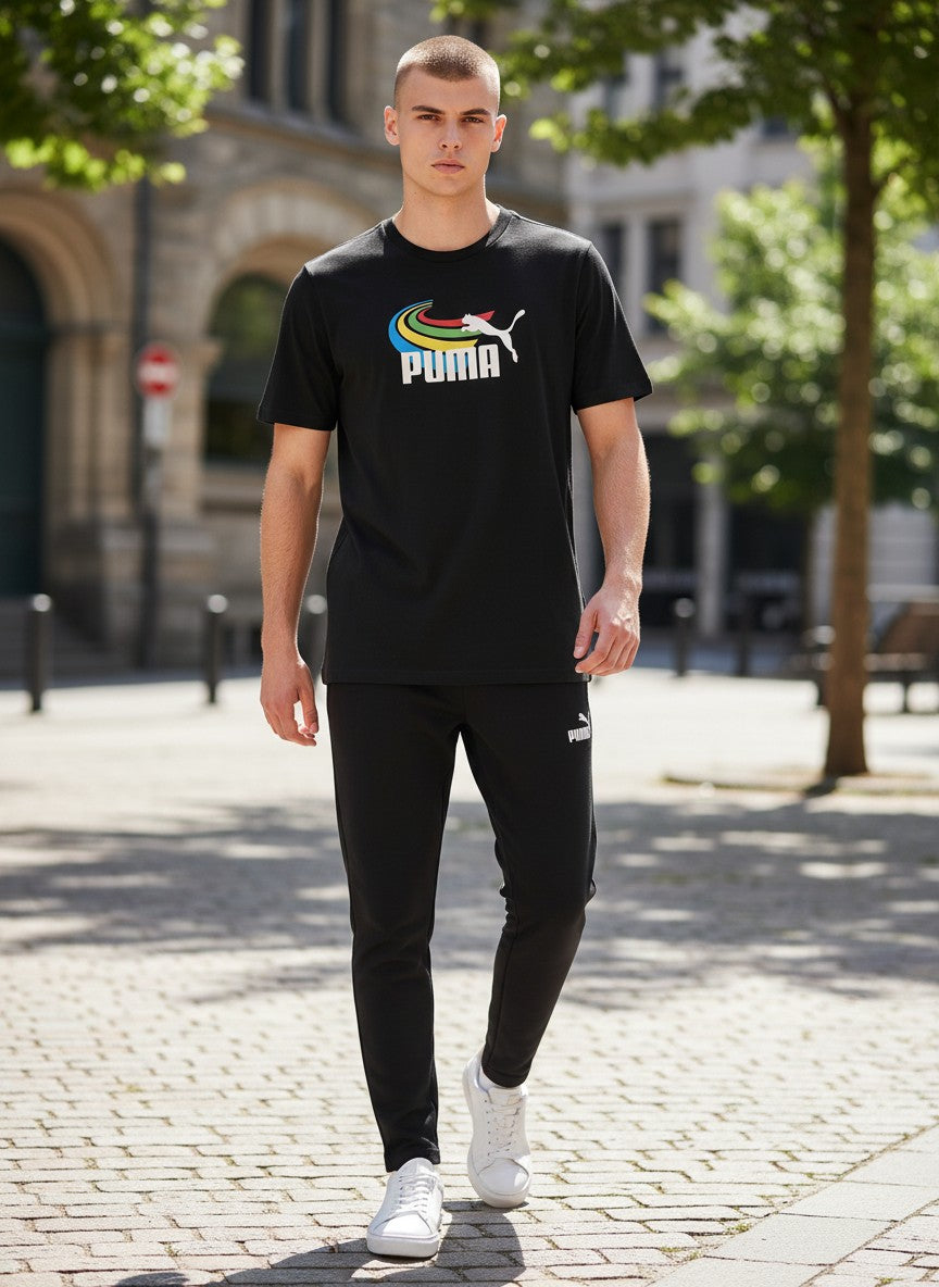 Person wearing a black Puma t-shirt and pants on a sunny street. Puma, Monza Outlet, Monza Fashion, Shein Outlet