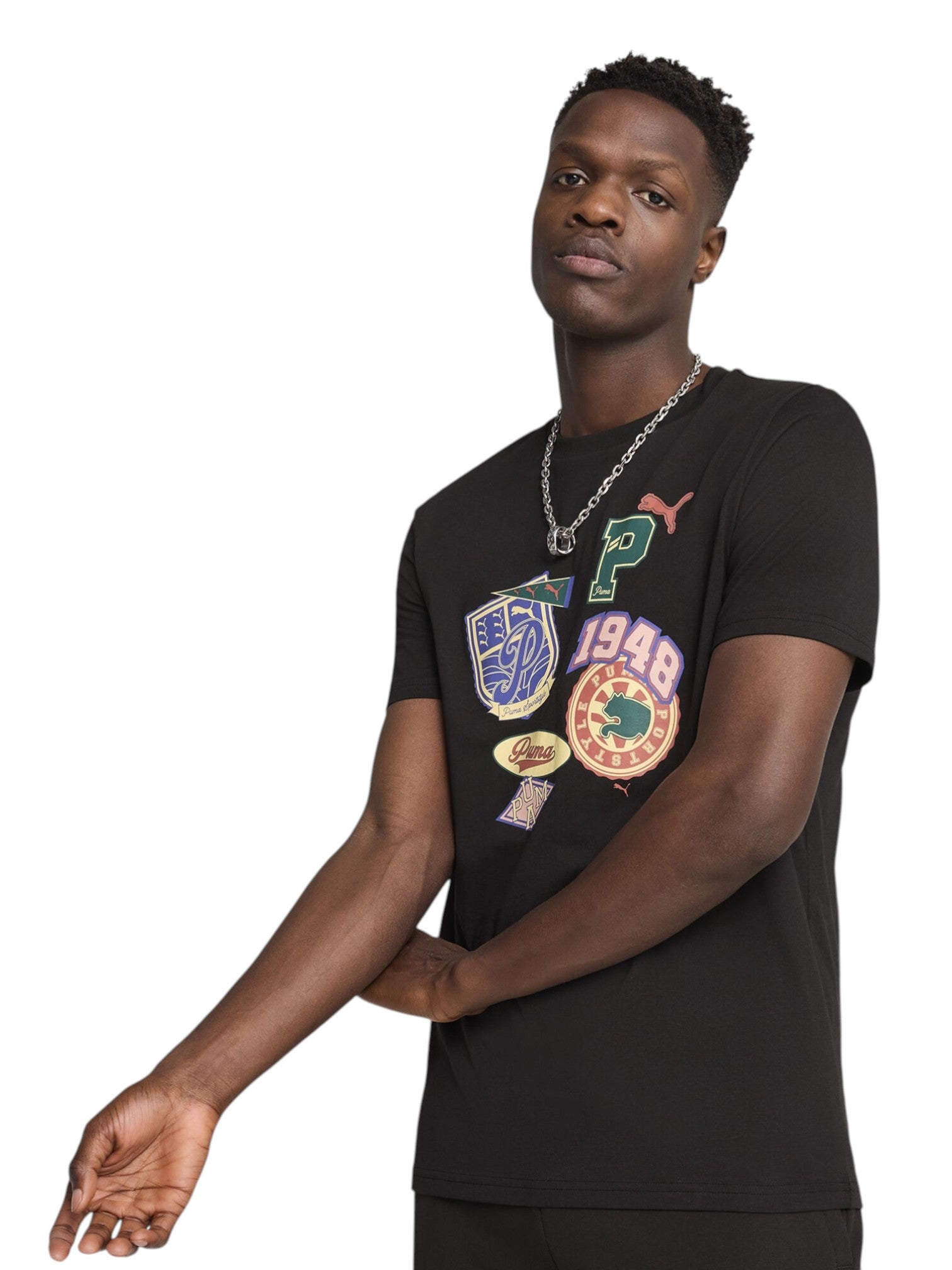 Man wearing a black t-shirt with colorful graphics on a white background. Puma, Monza Outlet, Monza Fashion, Shein Outlet