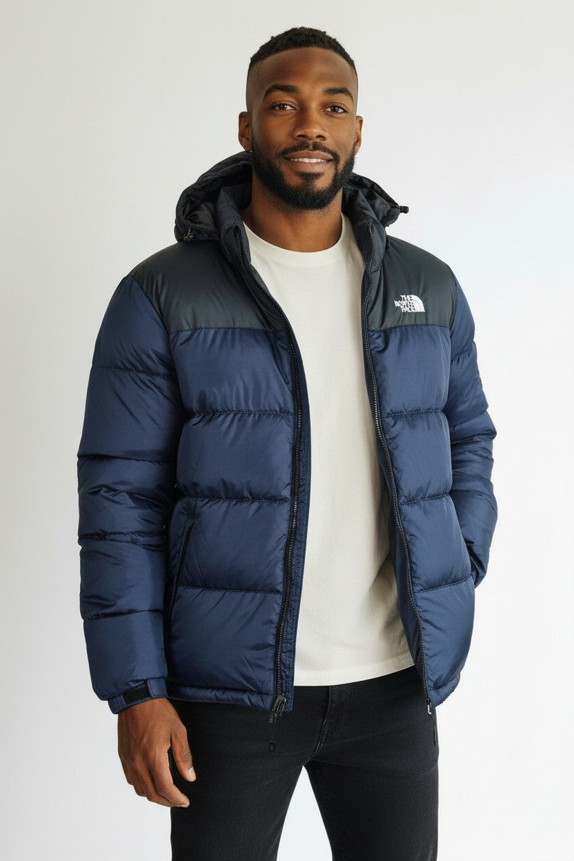 Man wearing a blue puffer jacket with The North Face logo on a white background. The North Face, Monza Outlet, Monza Fashion, Shein Outlet