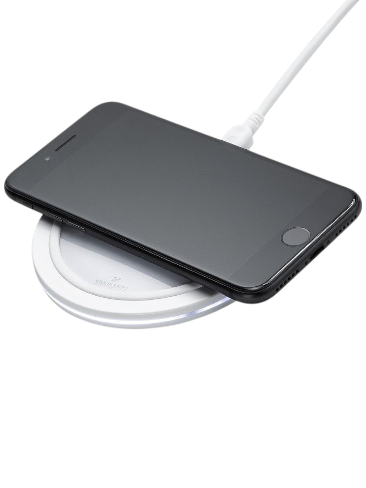 Black smartphone on a white wireless charging pad with a white cable. Swarovski Monza Outlet, Monza Fashion, Shein Outlet