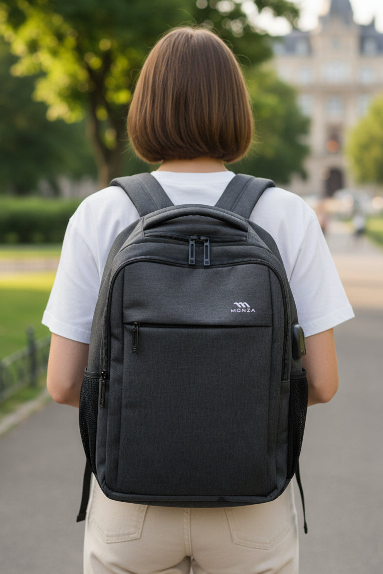 Person wearing a black backpack outdoors on a path with greenery and a building in the background. Monza Italy, Monza Outlet, Monza Fashion, Shein Outlet
