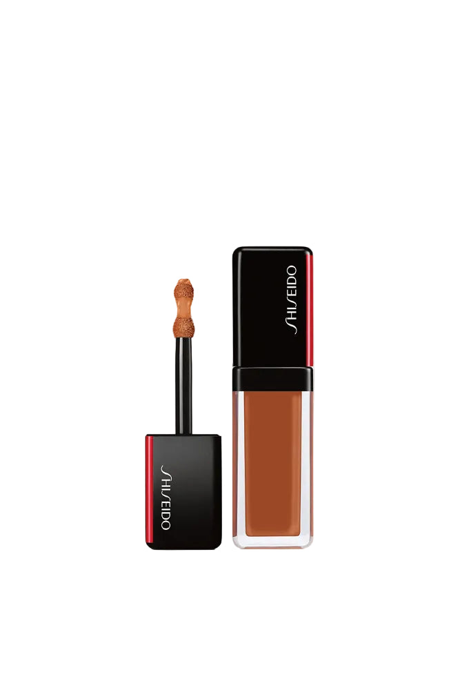 Shiseido makeup product with applicator on a white background Monza Outlet