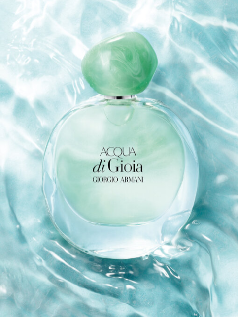 Giorgio Armani Acqua di Gioia perfume bottle on a water-like background. Monza Outlet