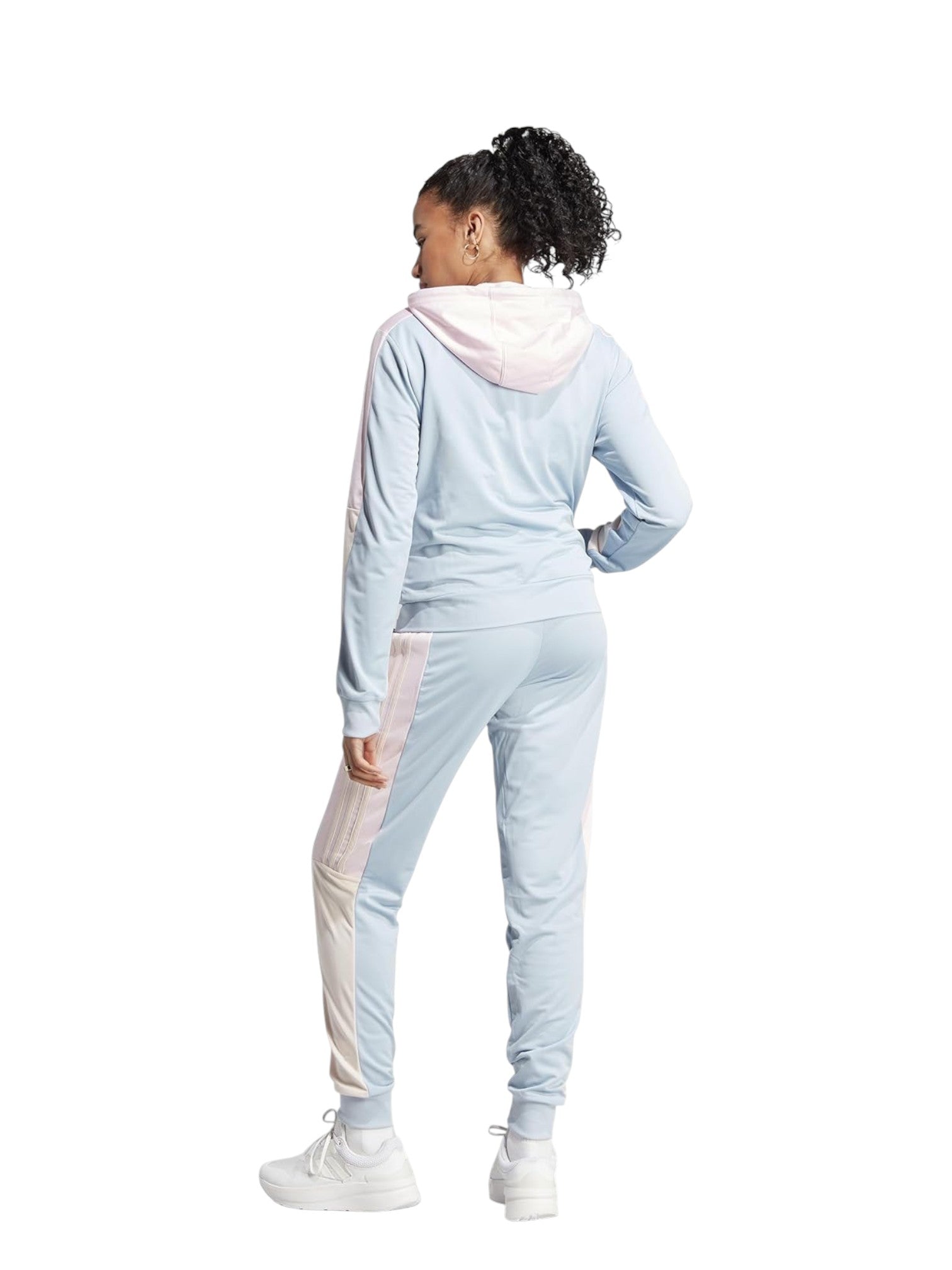 Person wearing a light blue tracksuit with a white background. Adidas, Monza Outlet, Monza Fashion, Shein Outlet