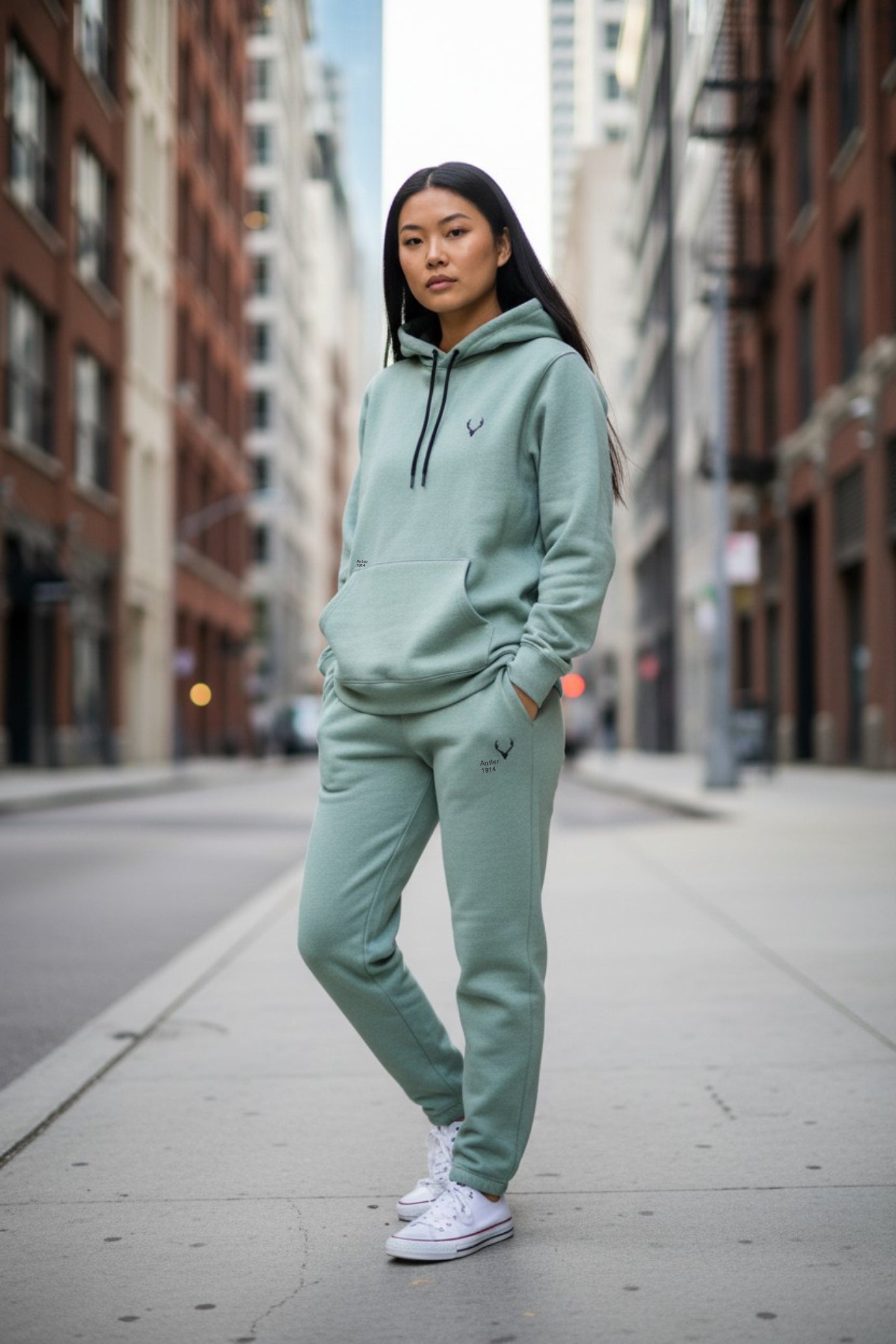 Person wearing a light green tracksuit on a city street. Antler, Monza Outlet, Monza Fashion, Shein Outlet