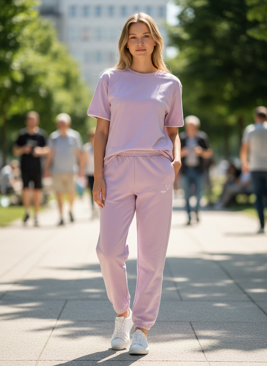 Woman in a pink outfit walking outdoors on a sunny day. Antler, Monza Outlet, Monza Fashion, Shein Outlet