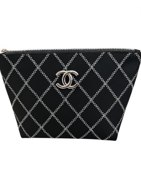 Black quilted handbag with silver logo on a white background. Chanel Monza Outlet