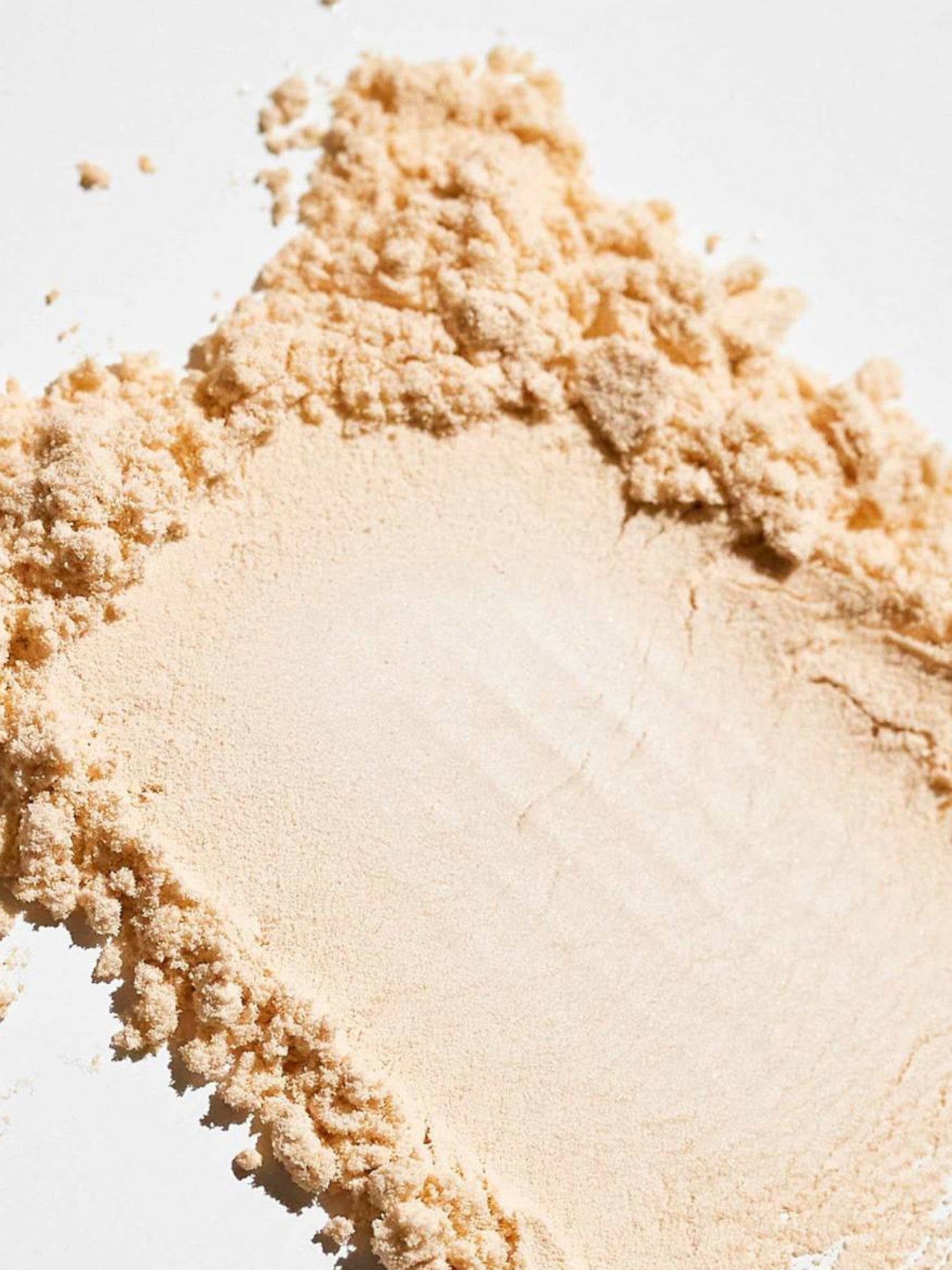 Close-up of beige powder on a white background monza outlet, Shein outlet, monza fashion