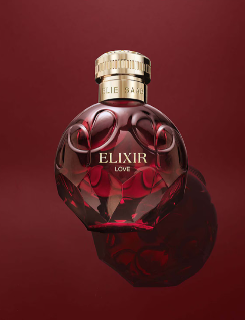 Red Elixir perfume bottle with gold cap on a red background monza outlet, Shein outlet, monza fashion