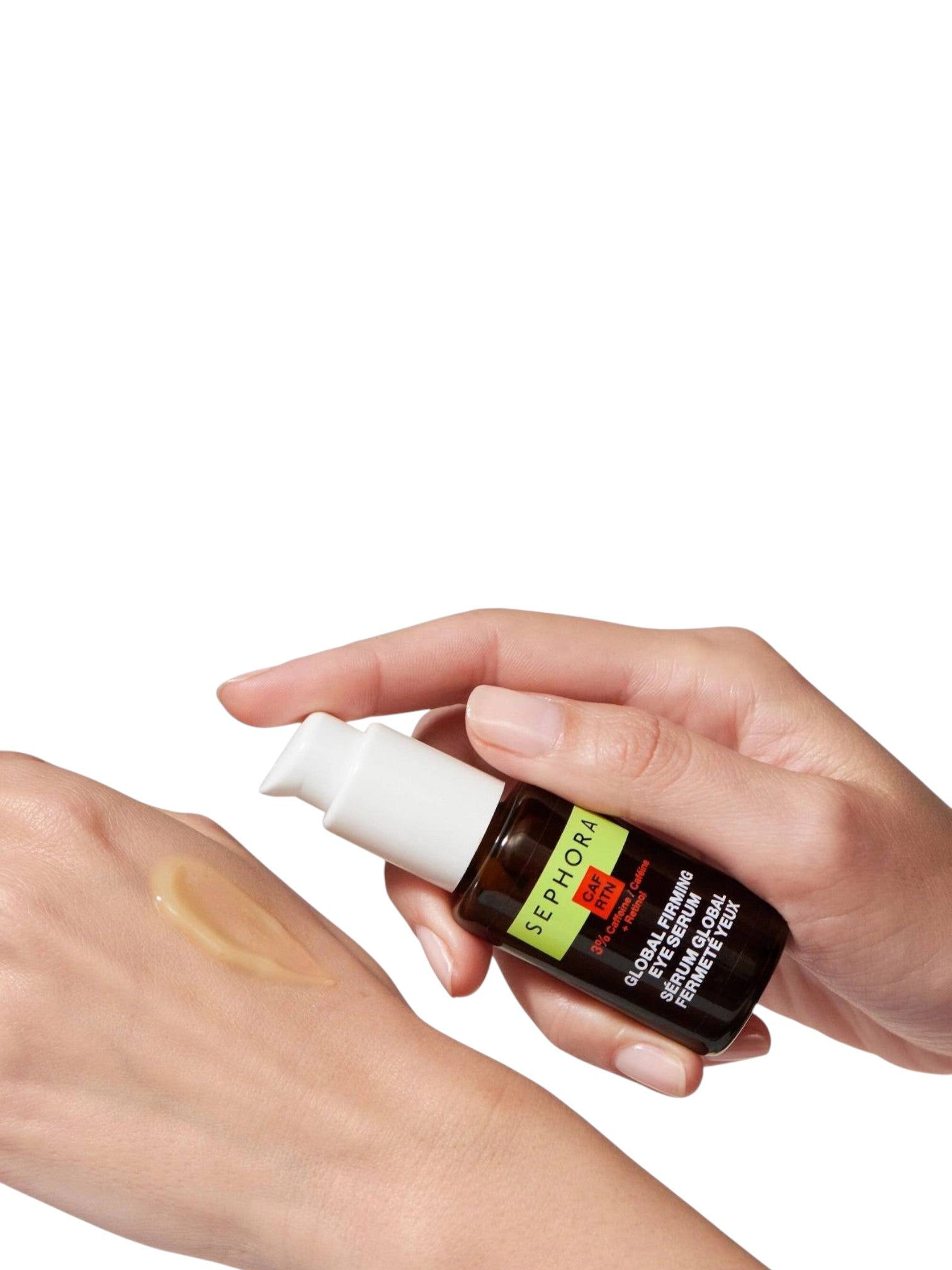 Hand holding a skincare bottle applying product to another hand on a white background monza outlet, Shein outlet, monza fashion