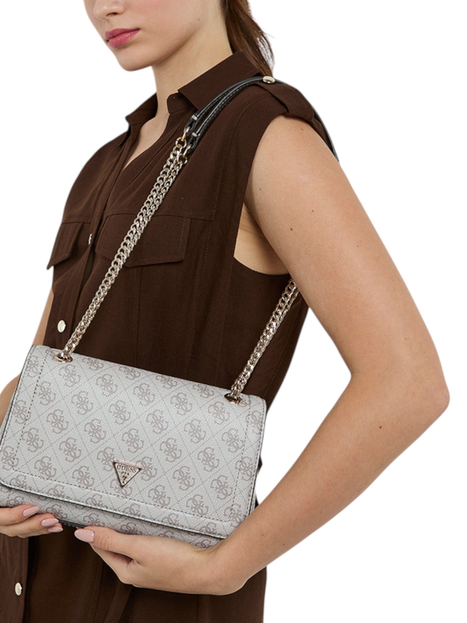 Woman holding a gray handbag with a brand logo on a white background. Guess, Monza Outlet, Monza Fashion, Shein Outlet