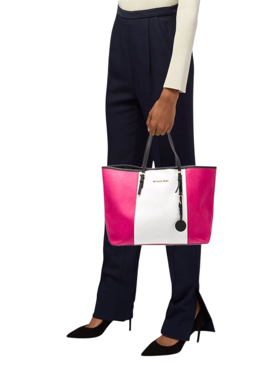 Person holding a pink and white handbag with a visible brand logo on a white background monza outlet, Shein outlet, monza fashion