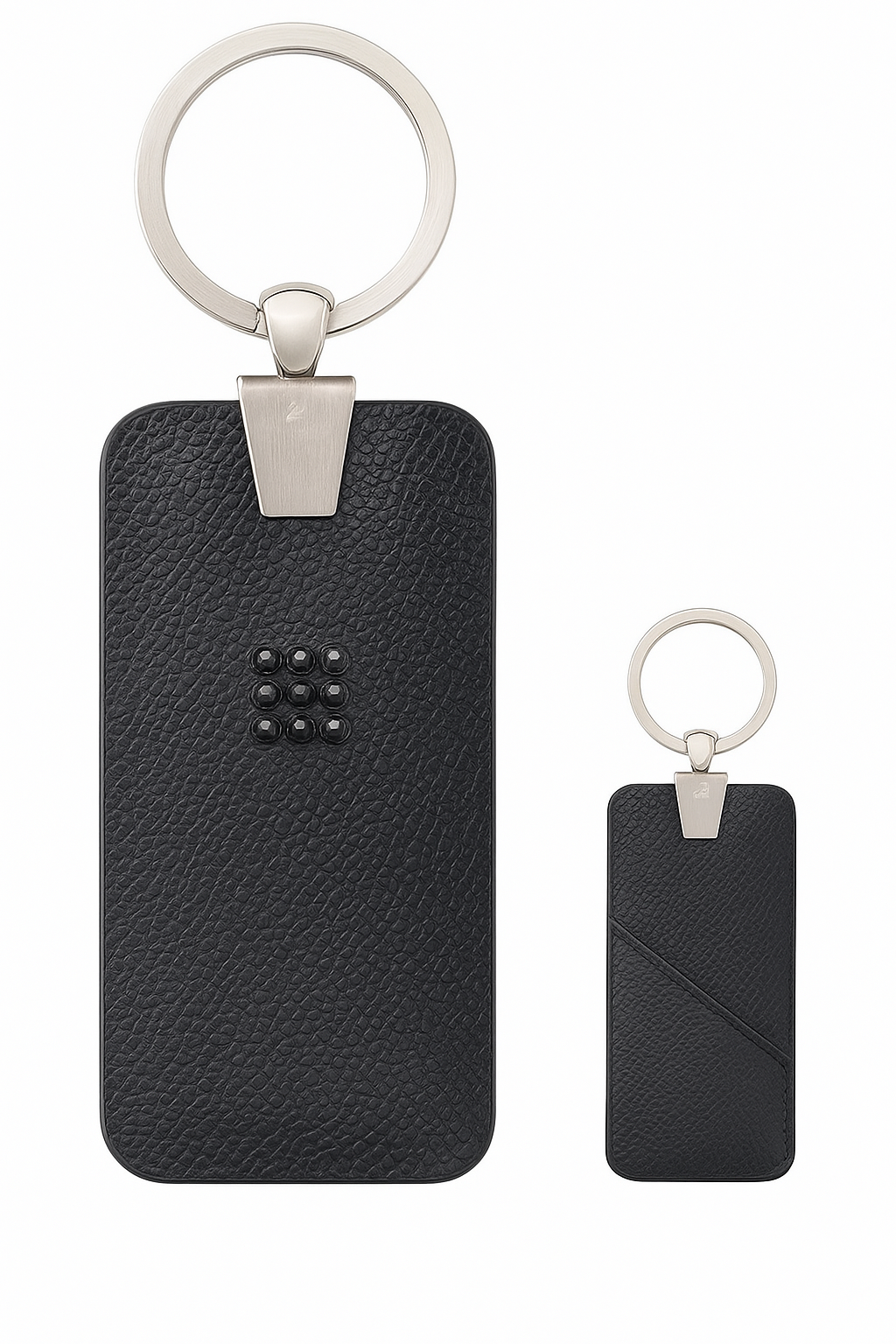 Two black leather keychains with silver key rings on a white background