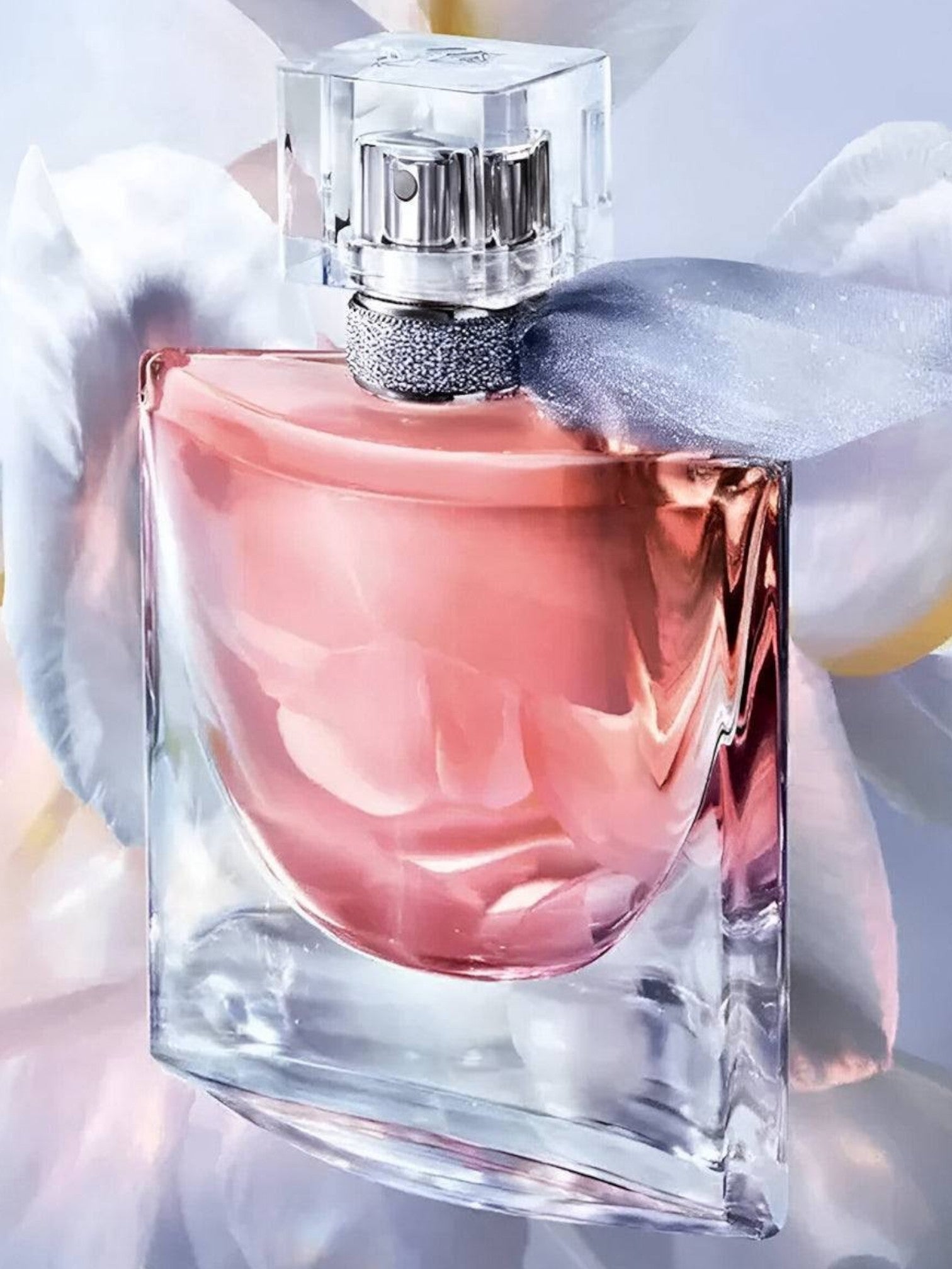 Pink perfume bottle with a white glove holding it against a soft, blurred background. Lancome, Monza Outlet, Monza Fashion, Shein Outlet