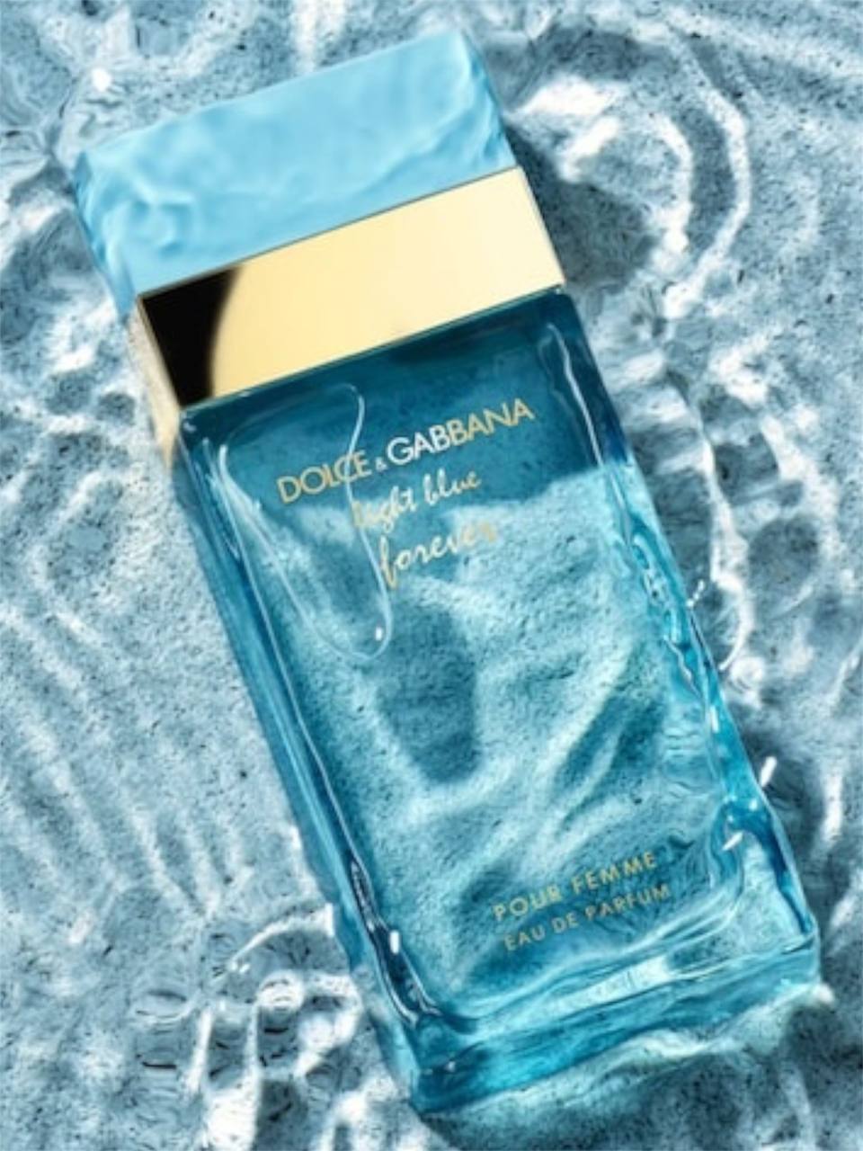 Dolce & Gabbana Light Blue Forever perfume bottle on a textured blue background Dolce Gabbana Monza Outlet