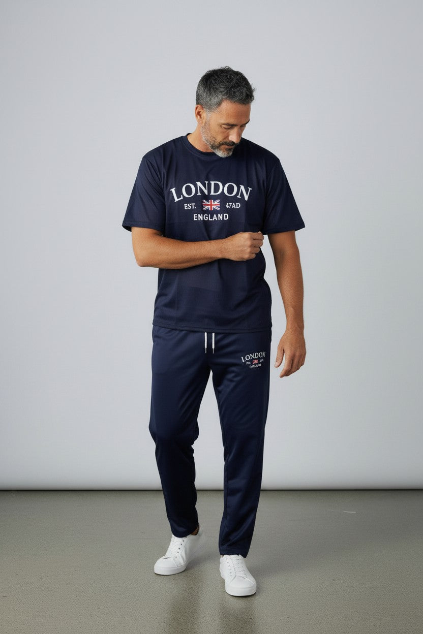 Man wearing a navy tracksuit with London England text on a plain background. Antler, Monza Outlet, Monza Fashion, Shein Outlet