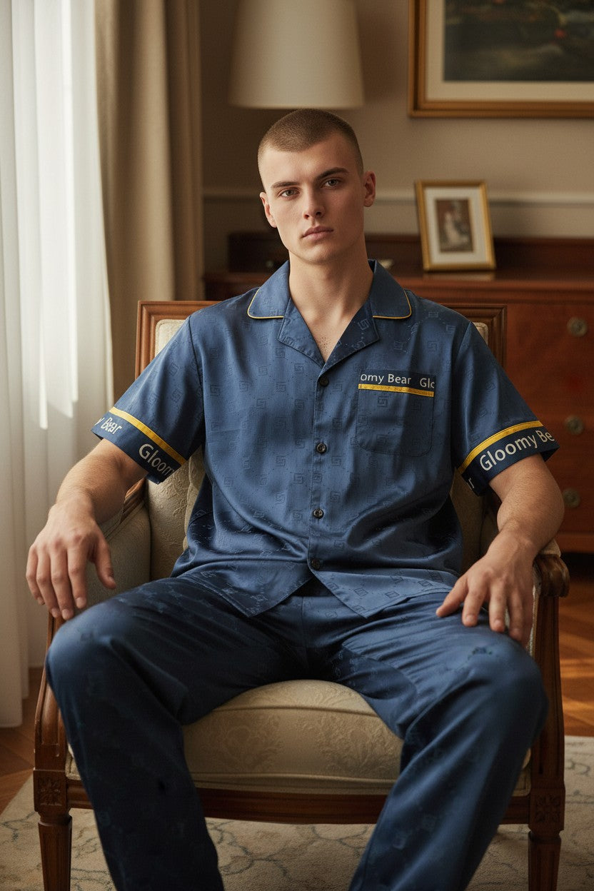 Man wearing a blue uniform sitting on a chair in a room with wooden furniture and framed pictures. Monza Italy, Monza Outlet, Monza Fashion, Shein Outlet