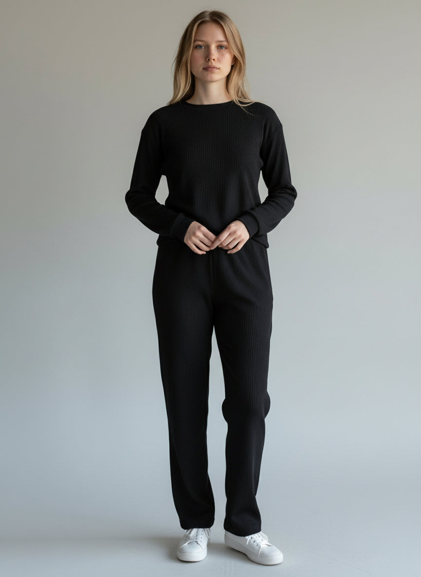 Person wearing a black outfit with white shoes on a plain background. Roncato, Monza Outlet, Monza Fashion, Shein Outlet