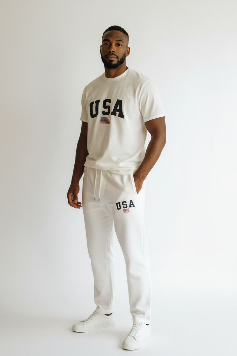 Man wearing a white USA t-shirt and pants on a plain background. Antler, Monza Outlet, Monza Fashion, Shein Outlet