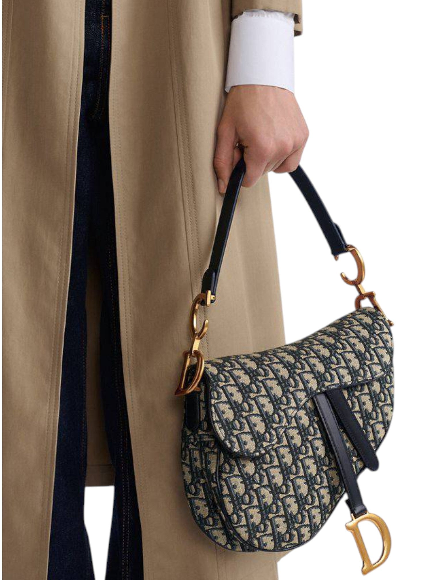 Person holding a patterned handbag with a visible brand logo, wearing a beige coat. monza outlet, Shein outlet, monza fashion