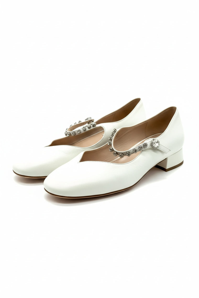 Pair of white shoes with embellishments on a white background. Miu Miu, Monza Outlet, Monza Fashion, Shein Outlet