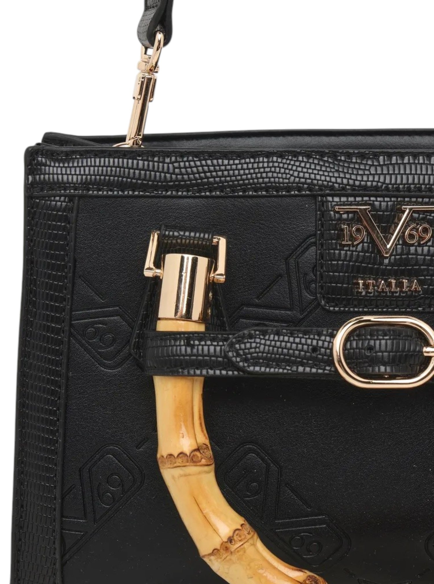Close up of a black leather handbag with embossed monogram pattern, gold tone hardware, and a curved natural bamboo handle, showing part of the flap and zipper. 19v69 Italia, Monza Outlet, Monza Fashion, Shein Outlet