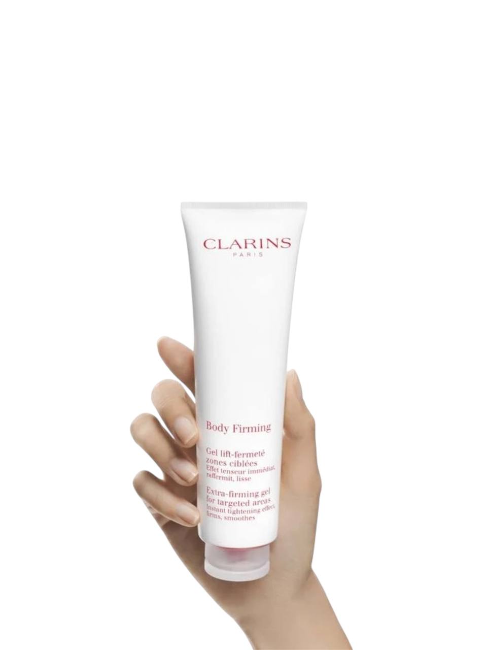 Hand holding a Clarins body firming product against a white background. Clarins, Monza Outlet, Monza Fashion, Shein Outlet