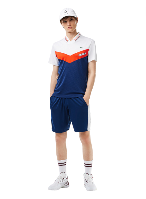 Person wearing a white and blue sports outfit with orange accents on a white background monza outlet, Shein outlet, monza fashion