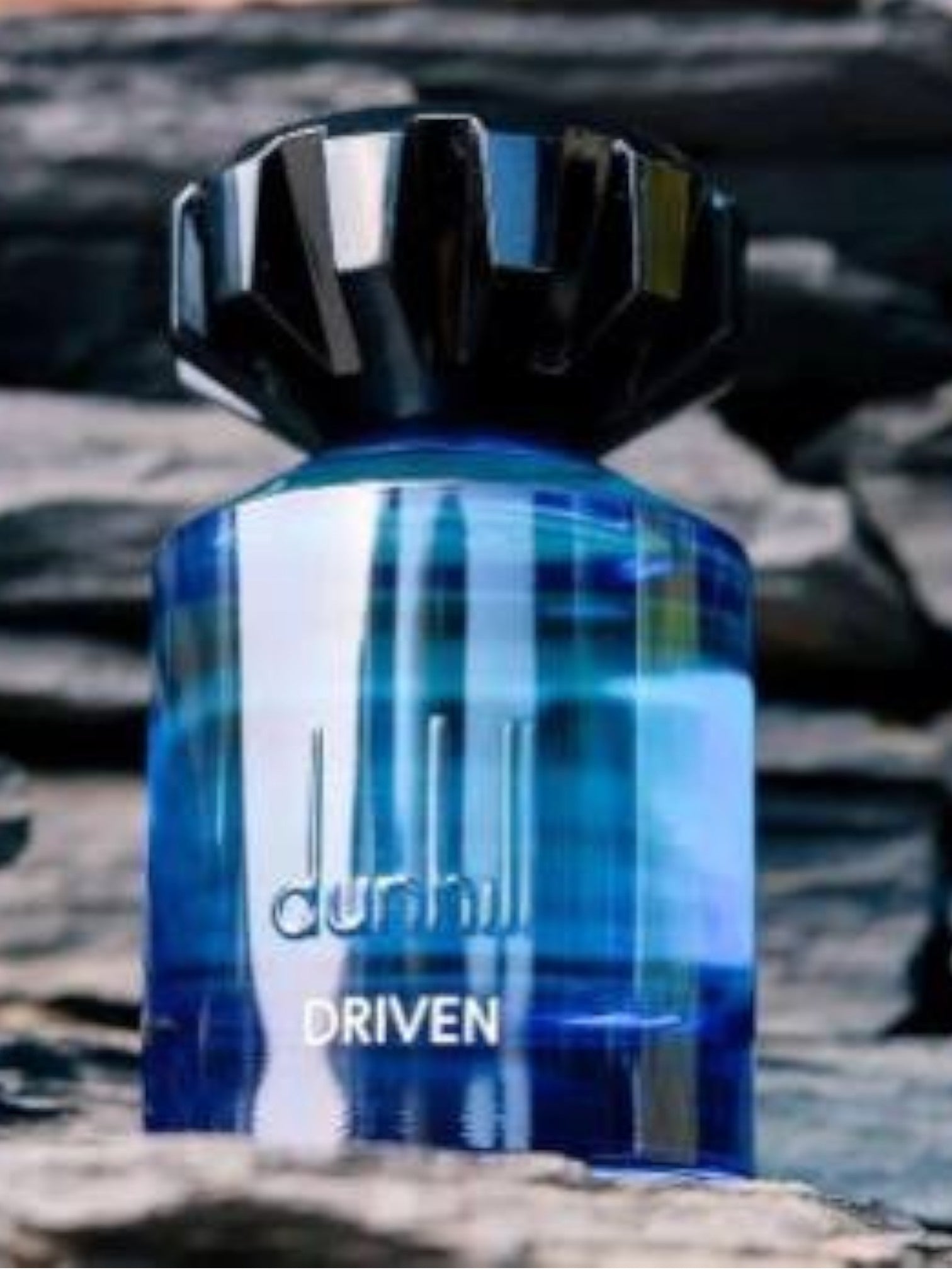 Blue Dunhill Driven perfume bottle on a textured surface. Dunhill, Monza Outlet, Monza Fashion, Shein Outlet