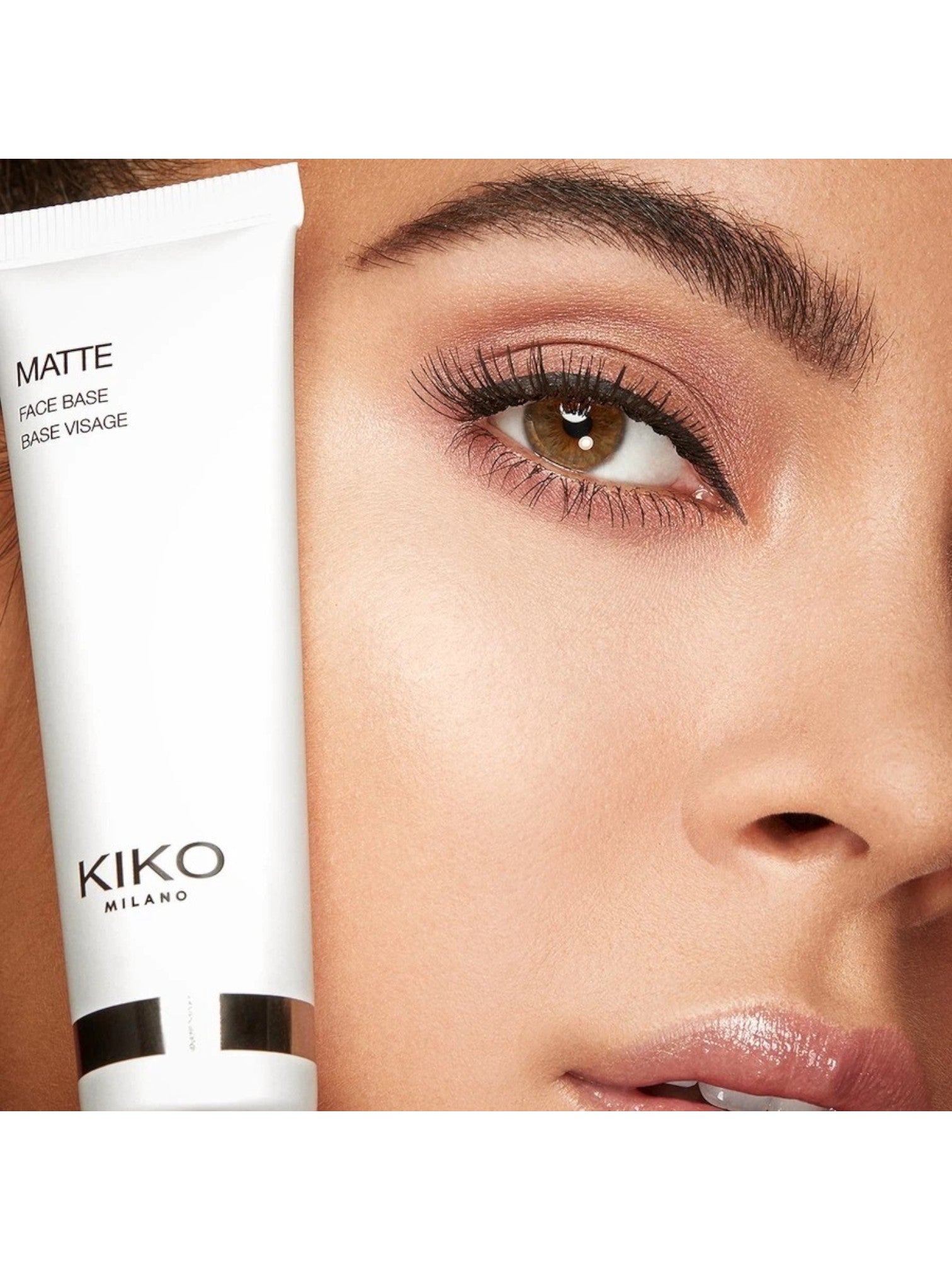 Kiko Milano cosmetic tube held up to a close-up of a woman's eye. Kiko, Monza Outlet, Monza Fashion, Shein Outlet