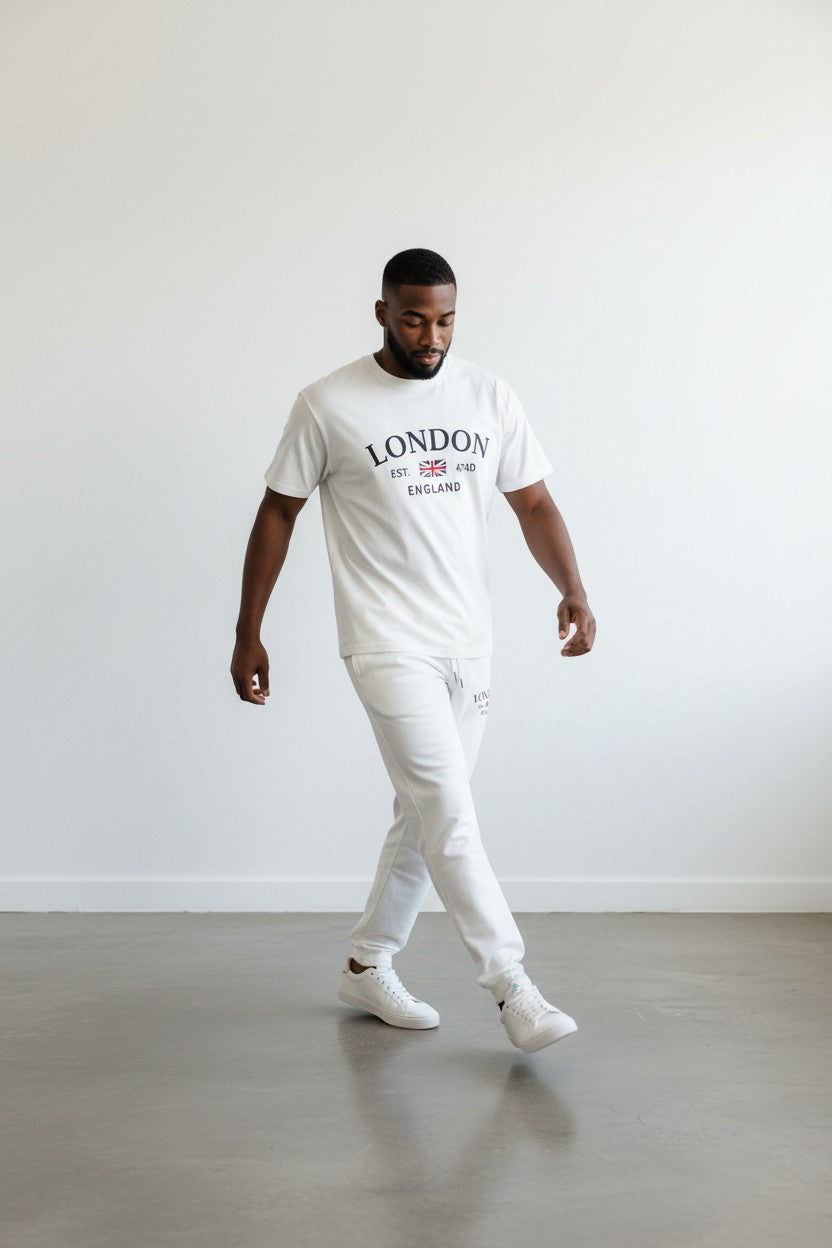 Man wearing a white t-shirt with London text and British flag design, standing against a plain background. Antler, Monza Outlet, Monza Fashion, Shein Outlet